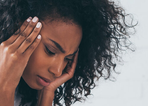 Photo of a woman with chronic headaches