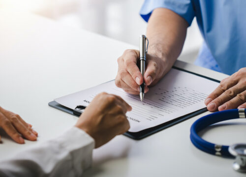 Photo of a doctor and a patient looking at the patient's medical chart